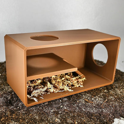 Reptile against glass viewing hide with added substrate that provides supplies and enrichment for reptiles.